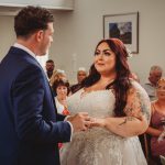 Bride and groom exchanging vows in ceremony.