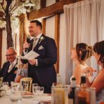 Groom giving wedding speech during reception.