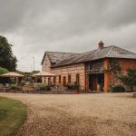 Charming countryside cottage with outdoor seating area.