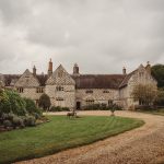 Historic countryside manor house with garden pathway.