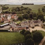 Aerial view of countryside village and historic estate.