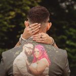 Couple embracing, wedding photo on man's back