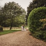 Couple standing on a gravel path in garden