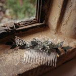 White floral hair comb on windowsill