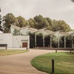 Glasshouse building in green park setting