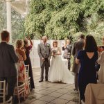 Bride and guests applaud indoors after ceremony