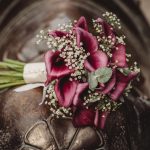 Purple calla lilies bouquet with baby's breath flowers.