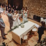 Bride and groom at rustic wedding ceremony.