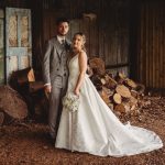 Bride and groom in rustic barn setting.