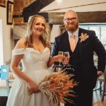 Bride and groom toasting with champagne indoors.