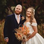 Bride and groom smiling outdoors