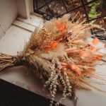 Autumnal dried flower bouquet on a windowsill.