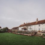 Charming country hotel with green lawn and gazebo.