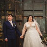 Bride and groom holding hands outdoors