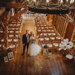 Bride and groom in rustic wedding venue.