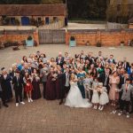 Large wedding group posing outdoors.