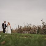 Wedding couple walking in scenic countryside