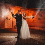 Bride and groom celebrating with champagne.