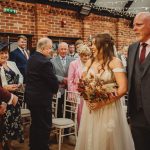 Bride smiling at groom during wedding ceremony