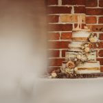 Three-tier wedding cake with floral decorations