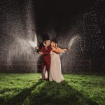 Couple celebrating wedding with champagne at night.