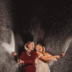 Couple celebrating with champagne at night