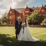 Bride and groom outside historic manor house