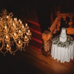 Elegant chandelier above wedding cake on stairs