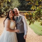 Bride and groom in garden path.