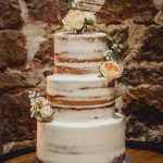 Three-tier rustic wedding cake with flowers