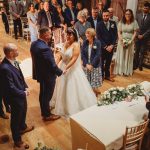 Bride and groom exchange vows at wedding ceremony.