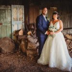 Bride and groom in rustic barn setting.