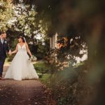 Bride and groom walking in a park