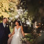 Bride and groom walking in a garden