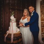 Bride and groom cutting wedding cake