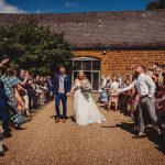 Bride and groom celebrating at outdoor wedding ceremony.