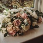 Bouquet of roses on a windowsill.