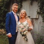 Bride and groom smiling outdoors