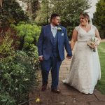 Bride and groom walking in garden