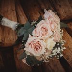 Pink rose bouquet on wooden surface