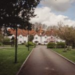 Pathway leading to charming white country building.