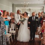 Bride walking down aisle with her father.