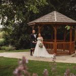 Bride and groom at garden gazebo wedding.