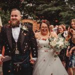 Happy bride and groom at outdoor wedding celebration.