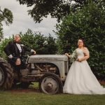 Bride and groom with tractor in garden