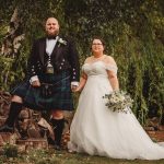 Bride and groom in garden wedding attire.