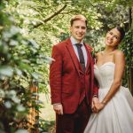 Happy couple on wedding day outdoors.