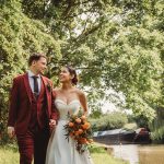 Couple walking by canal on wedding day