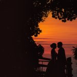 Silhouetted couple kissing at sunset