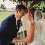 Laughing bride and groom outdoors on wedding day.